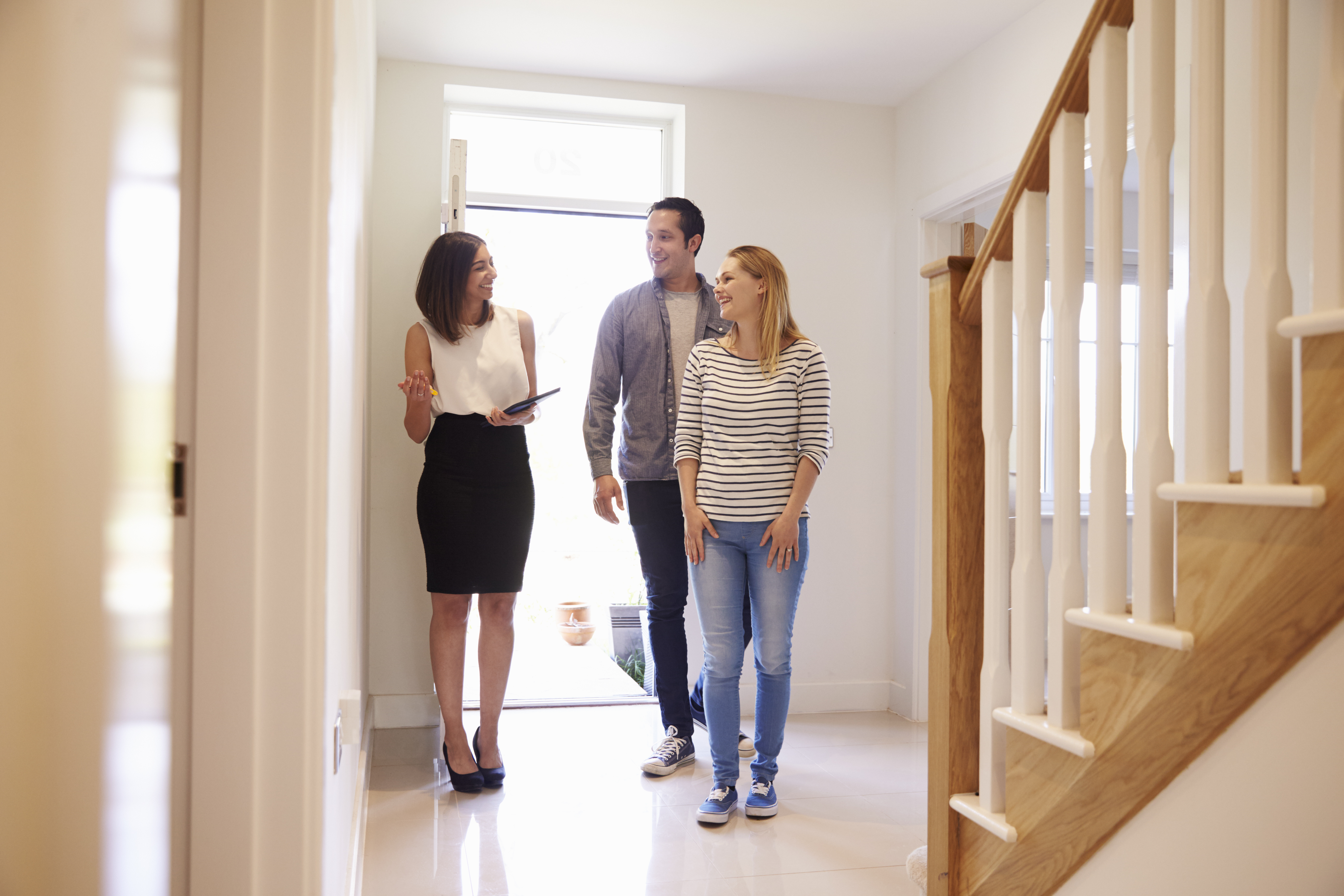 Realtor showing a home to a young couple